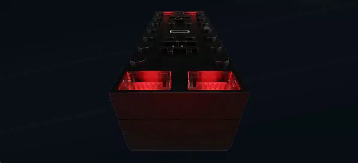 Best Bluetooth Battery Hubs for LEGO Technic: Power Functions and Powered Up Upgrades 2 The BuWizz 3.0 Pro hub seen from above against a dark background, two of its ports glowing red and a USB-C socket on the top face, with LEGO style studs around the edge