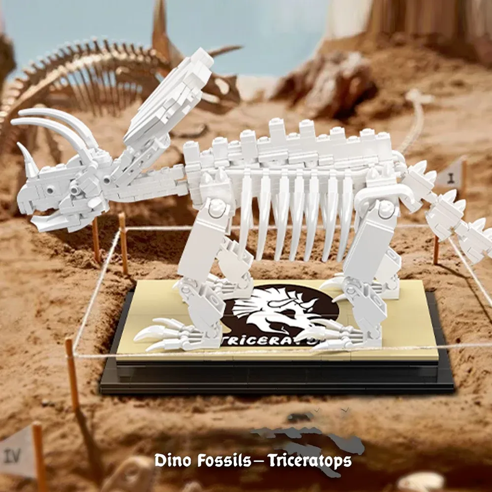 A white brick built Triceratops skeleton mounted on a dark display plinth with a Triceratops nameplate, photographed against a dig site background