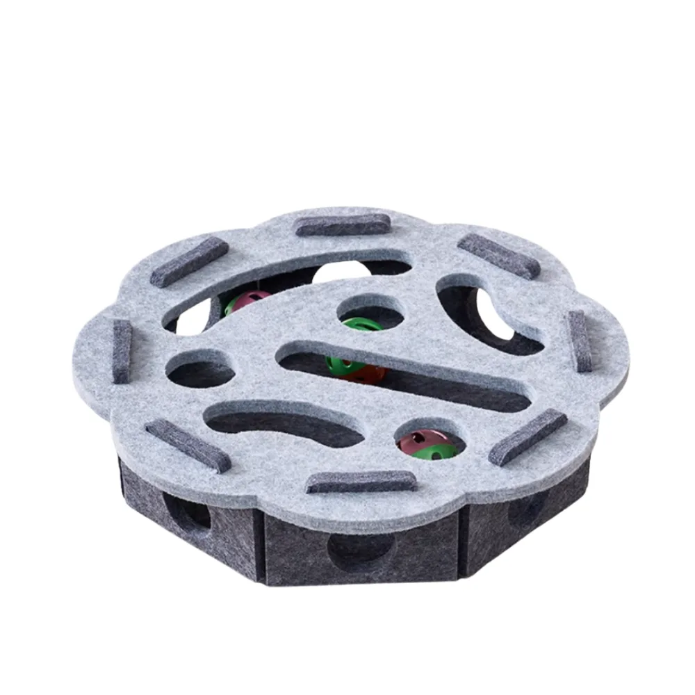 A round grey felt play box with slots and holes cut into its lid, with small coloured bell balls visible inside