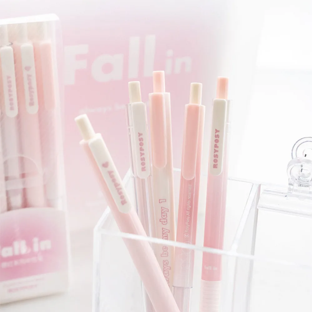 Best Journaling Supplies and Aesthetic Stationery: How to Build a Complete Kit in 2026 2 Six pale pink and cream push-type gel pens standing in a clear acrylic holder, with the Fall in retail box behind them