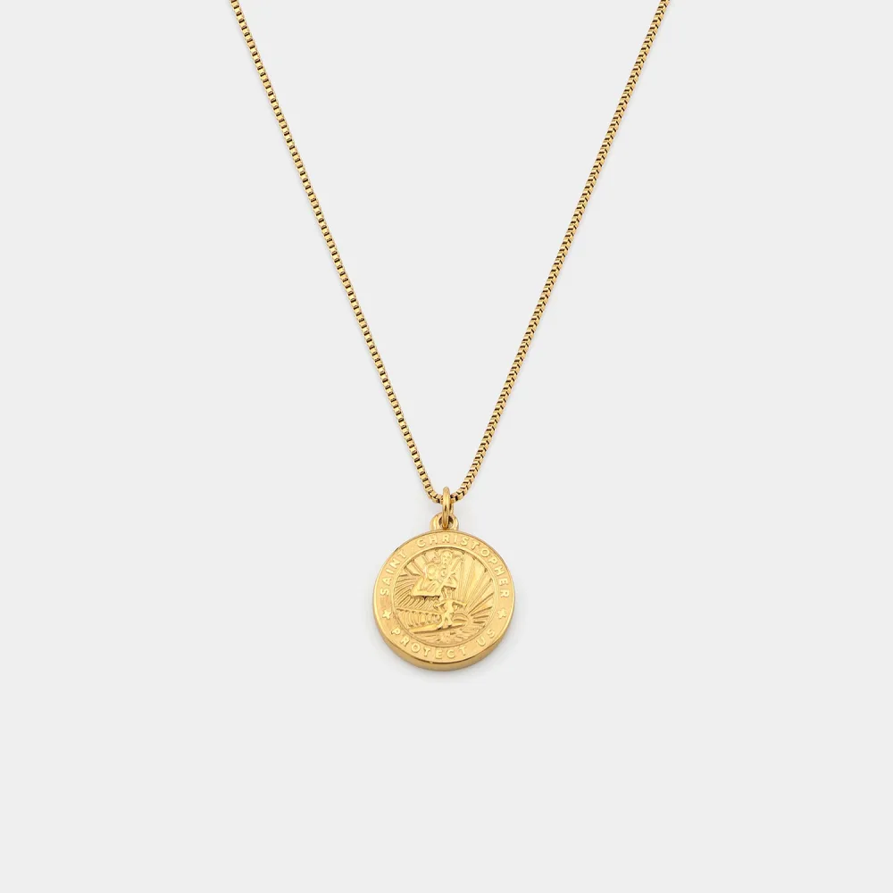 Best St. Christopher Surf Necklaces: A Guide to Get Back's Surfer Medallions 2 A gold St. Christopher medallion with no coloured enamel, hanging from a fine gold box chain