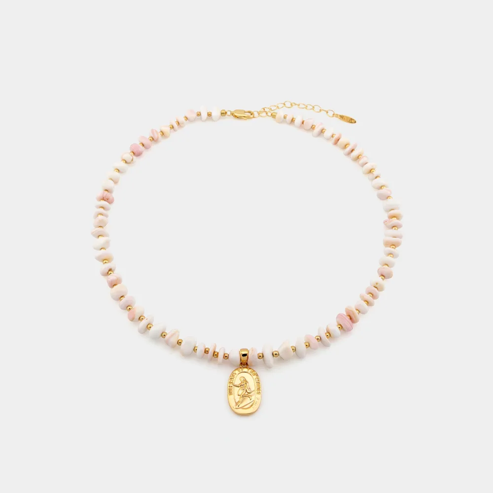 Best St. Christopher Surf Necklaces: A Guide to Get Back's Surfer Medallions 5 A beaded necklace of pink and cream shell chips with small gold spacer beads and a gold oval Our Lady of the Waves medallion showing a female surfer