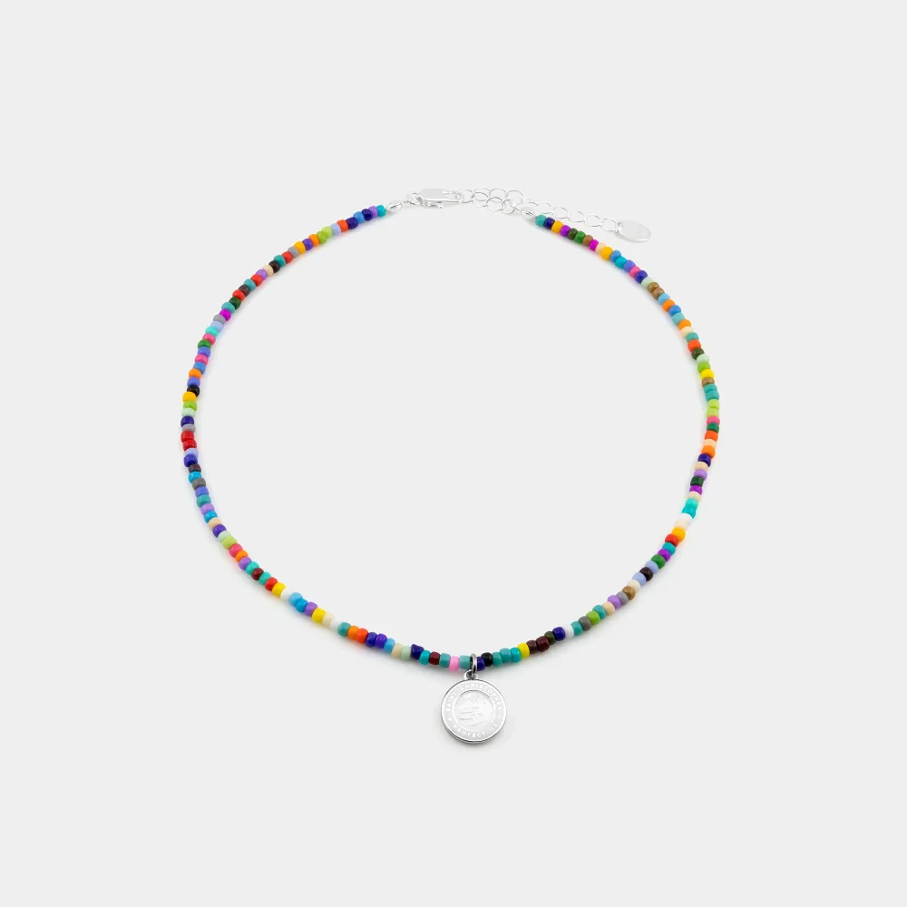 Best St. Christopher Surf Necklaces: A Guide to Get Back's Surfer Medallions 8 A choker of multicoloured seed beads with a small round silver St. Christopher medallion and an adjustable extender chain