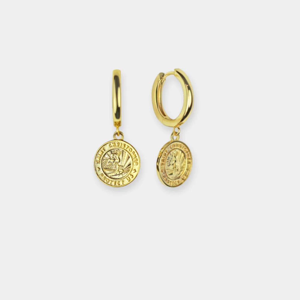 Best St. Christopher Surf Necklaces: A Guide to Get Back's Surfer Medallions 7 A pair of gold huggie hoop earrings, each with a small round St. Christopher medallion charm hanging from the hoop