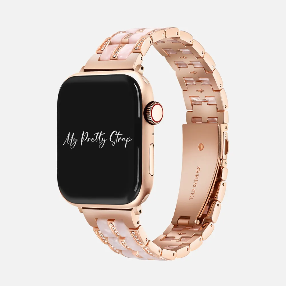 Best Apple Watch Bands That Look Like Jewelry 5 A rose gold Apple Watch on a strap alternating pale pink resin segments with bars of small pavé set crystals, the clasp stamped stainless steel