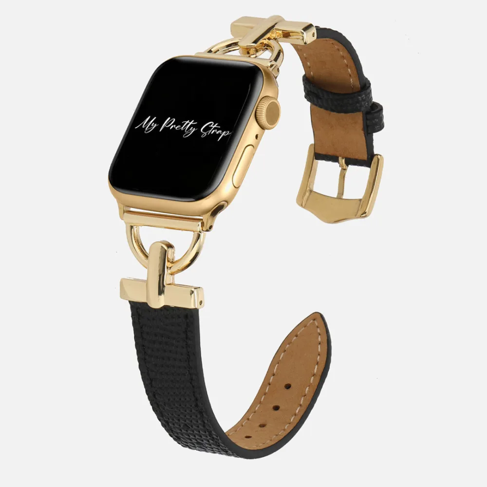Best Apple Watch Bands That Look Like Jewelry 8 A gold Apple Watch on a black textured leather strap with a tan underside, gold D ring connectors at the case and a gold pin buckle