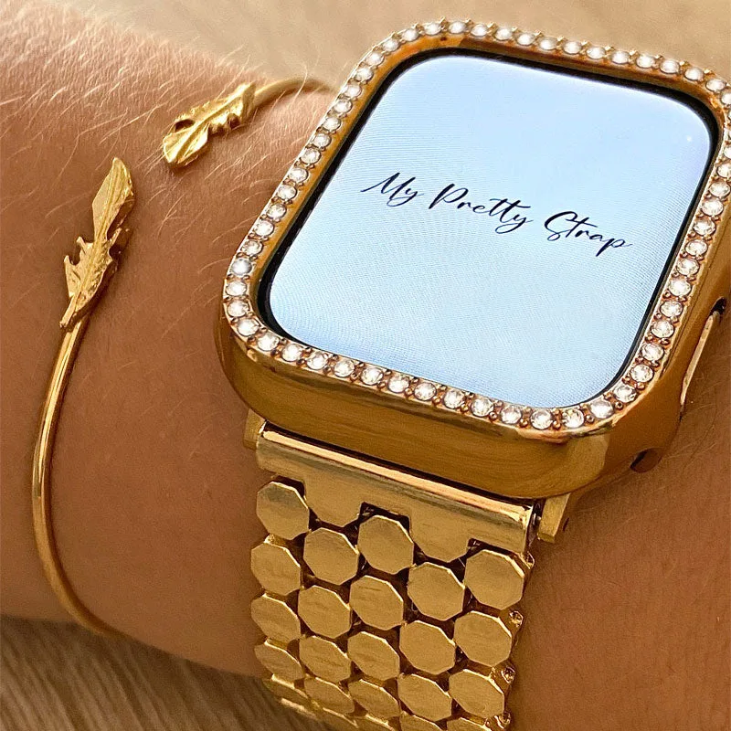 Best Apple Watch Bands That Look Like Jewelry 6 A gold Apple Watch worn on a wrist with a honeycomb pattern gold link bracelet and a crystal set bezel cover fitted around the screen, next to a thin gold feather bangle