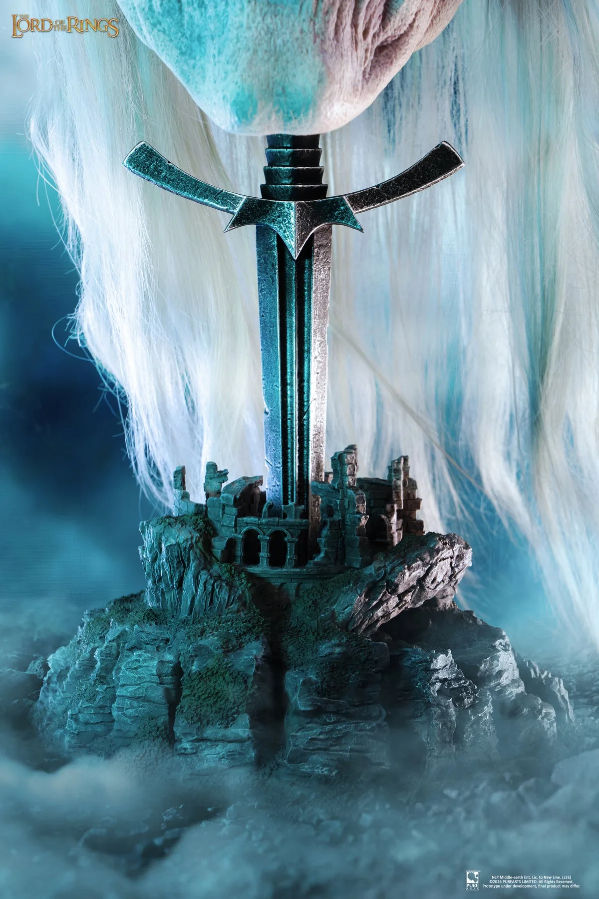 Close view of the display base: a Morgul blade driven into a miniature ruined stone tower on a rocky outcrop, with the mask's white hair falling around it