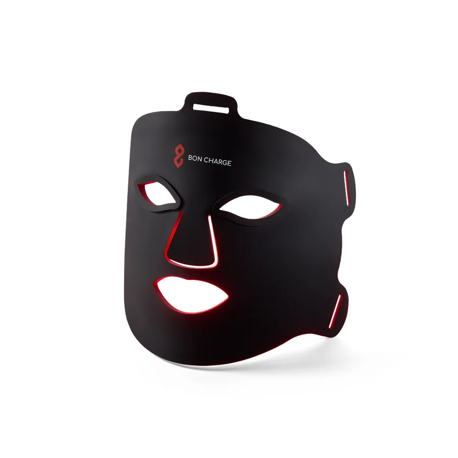 BON CHARGE Red Light Face Mask, a flexible black silicone mask with eye, nose and mouth cutouts, red light glowing along the inner edges