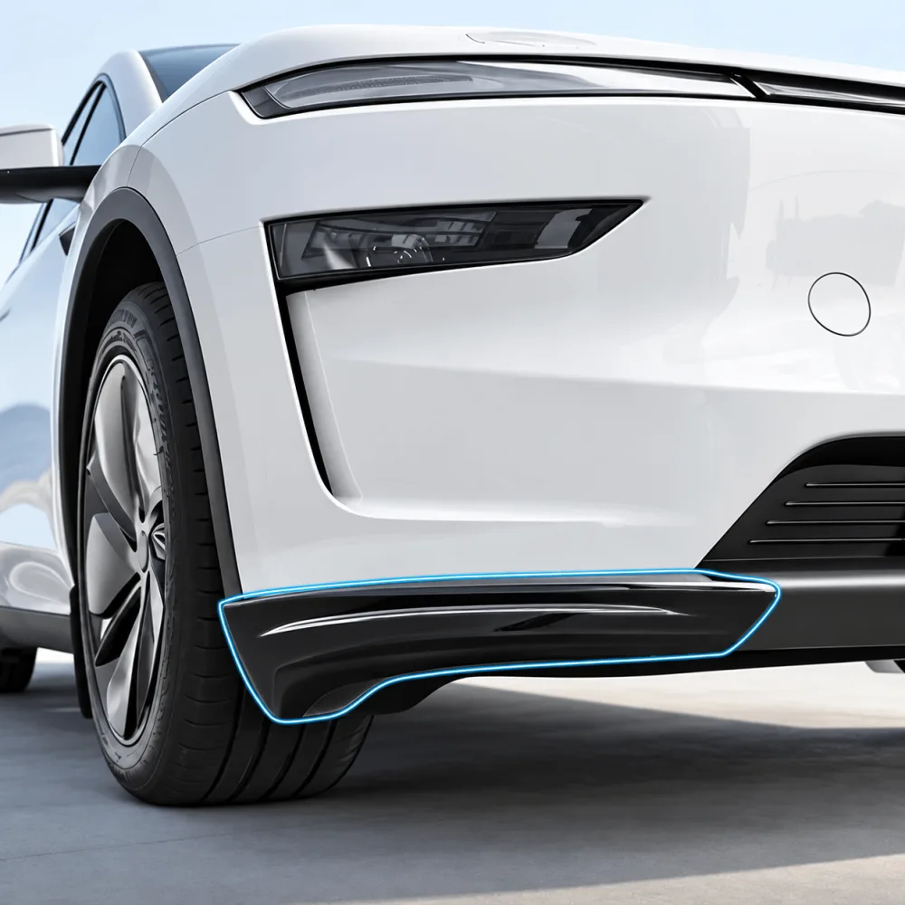 The front corner of a white Tesla Model Y Juniper with its full width front light bar, the lower bumper corner guard outlined in blue to show where it fits