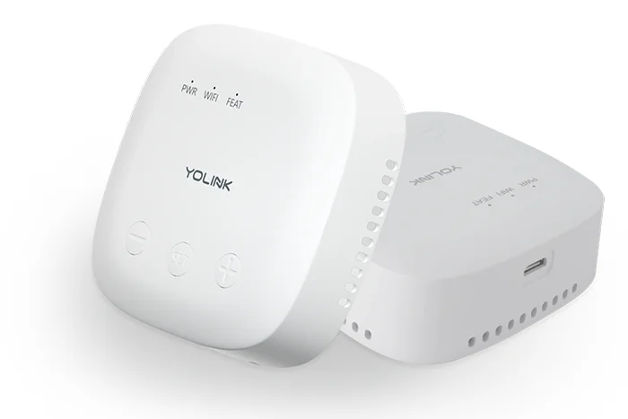 Two white YoLink hubs, one showing the front face with power, WiFi and feature indicator lights and three buttons, the other showing the USB power port on the rear